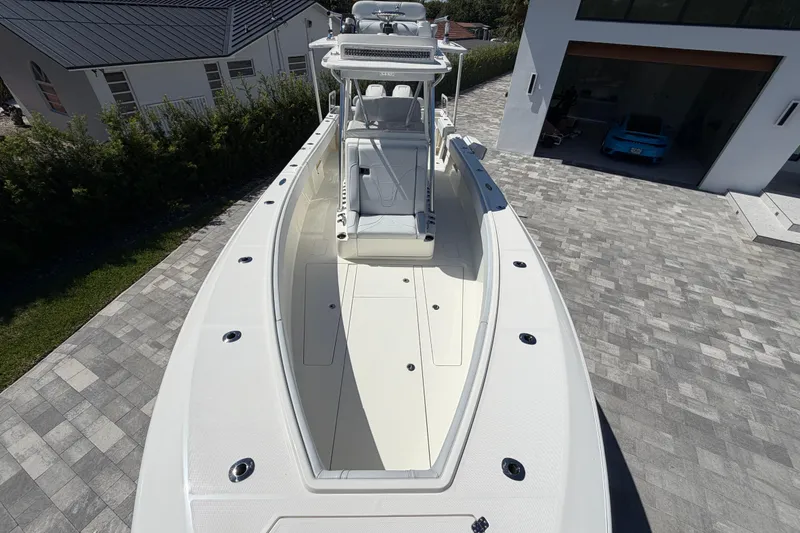 Slide: The Image of 2021 SeaVee 322Z boat on paved driveway, showcasing sleek design and spacious deck. - 18