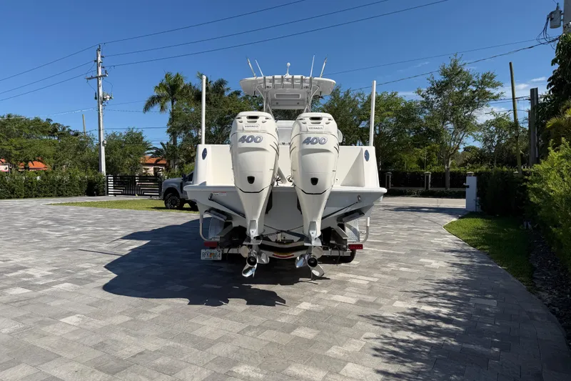 Slide: The Image of 2021 SeaVee 322Z boat with twin 400 horsepower engines on a sunny driveway. - 3