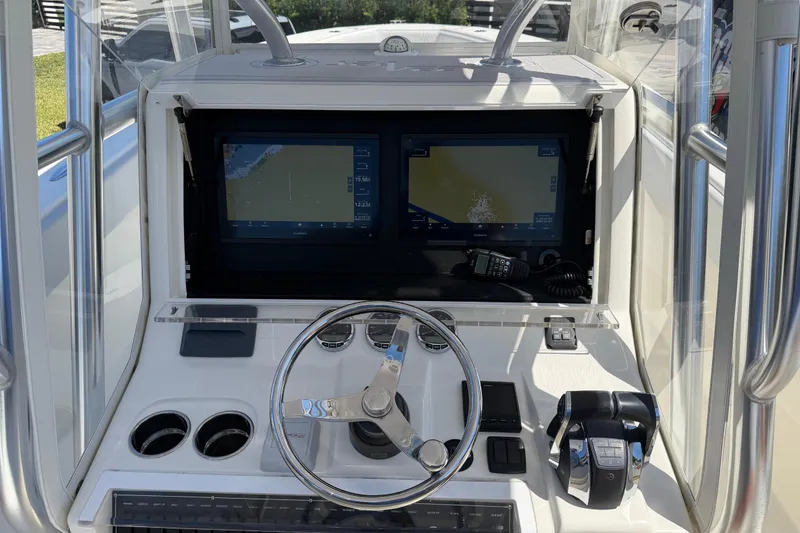 Slide: The Image of 2021 SeaVee 322Z boat helm with dual navigation screens and steering wheel. - 4