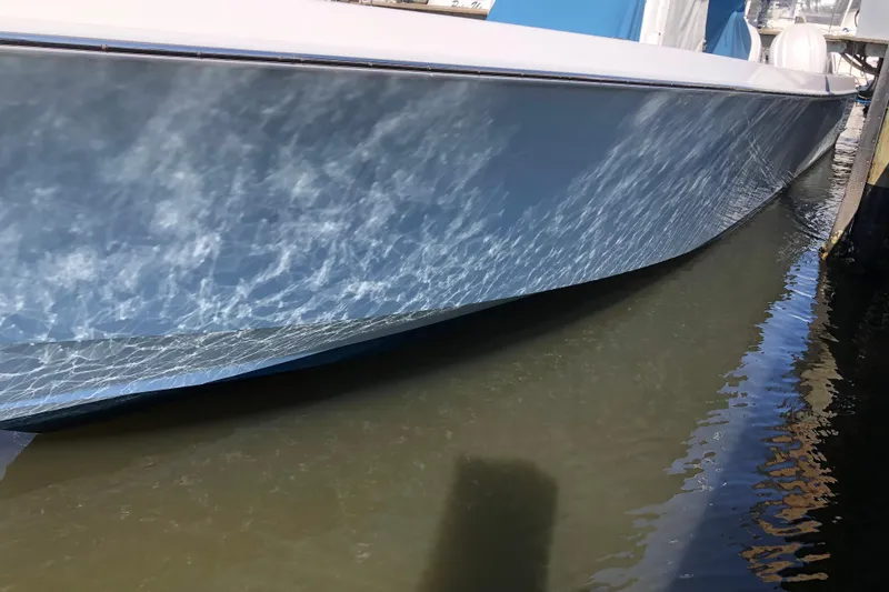Slide: The Image of 2009 Contender 33 Tournament boat reflecting sunlight on water. - 11