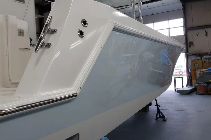 Slide: The Image of 2009 Contender 33 Tournament boat in a workshop, showcasing sleek hull design. - 14