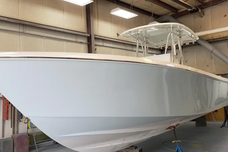 Slide: The Image of 2009 Contender 33 Tournament boat in a workshop, showcasing sleek design and craftsmanship. - 16