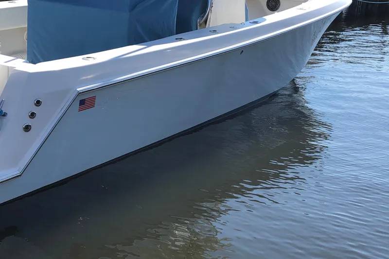 Slide: The Image of 2009 Contender 33 Tournament boat docked on calm water. - 2