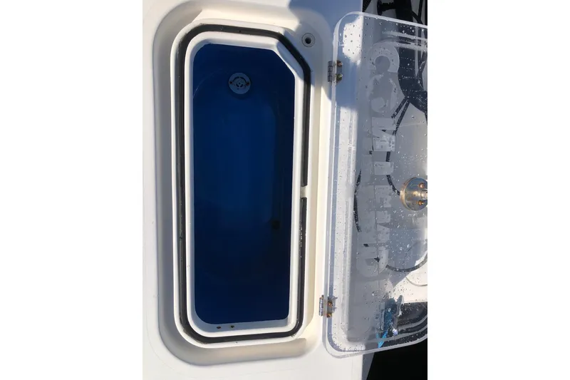 Slide: The Image of Livewell compartment on a 2009 Contender 33 Tournament boat, open with visible blue interior. - 3