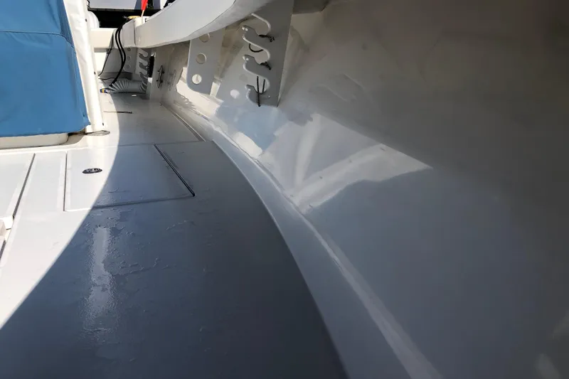 Slide: The Image of Interior view of a 2009 Contender 33 Tournament boat, showcasing sleek design and storage compartments. - 7