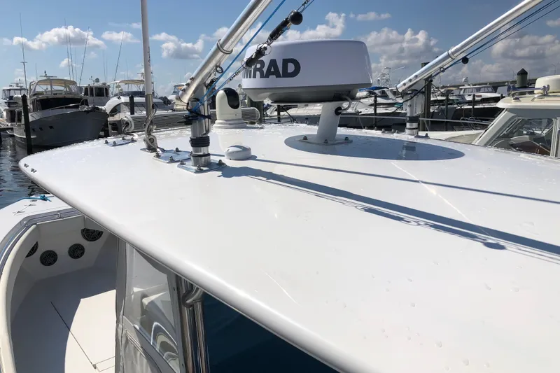 Slide: The Image of 2009 Contender 33 Tournament boat with radar, docked at marina under blue sky. - 8