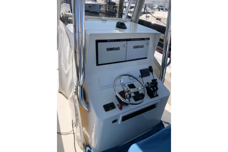 Slide: The Image of 2009 Contender 33 Tournament boat helm with Simrad electronics and steering wheel. - 9