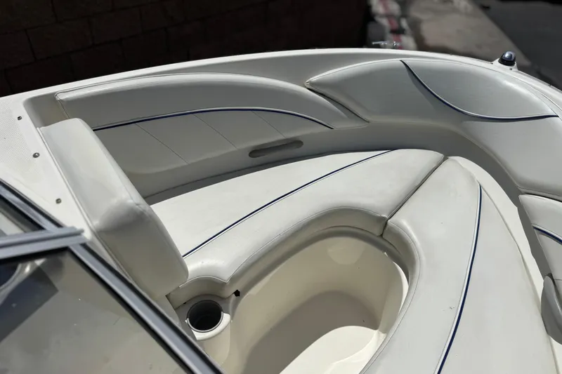 Slide: The Image of 2006 Bayliner 195 Bowrider boat interior with white cushioned seating. - 10