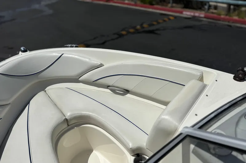 Slide: The Image of 2006 Bayliner 195 Bowrider boat interior with white cushioned seating. - 11