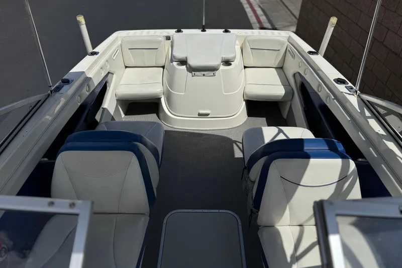 Slide: The Image of 2006 Bayliner 195 Bowrider interior with white and blue seating, open layout. - 12