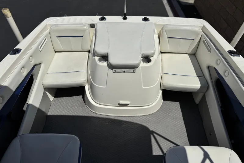 Slide: The Image of 2006 Bayliner 195 Bowrider interior with white seating and storage compartments. - 13