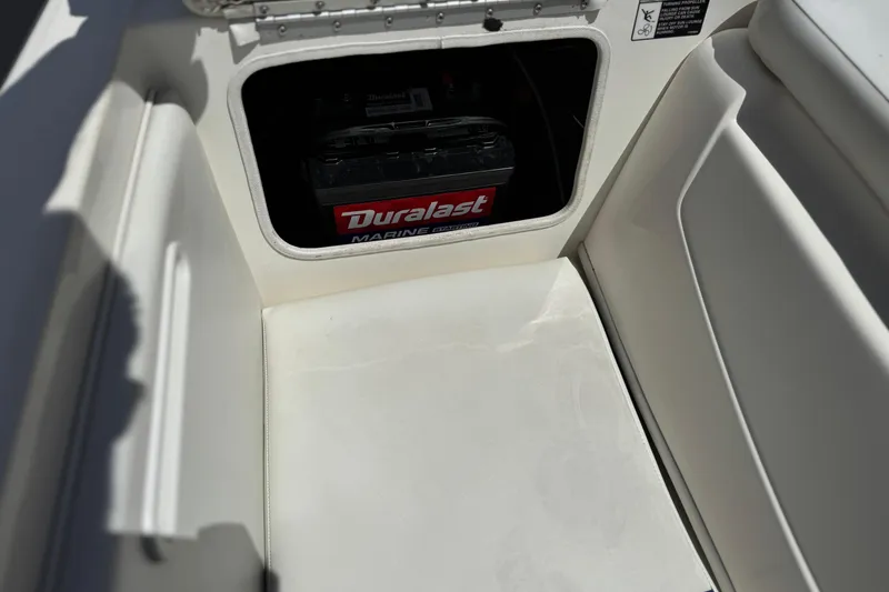 Slide: The Image of 2006 Bayliner 195 Bowrider battery compartment with Duralast marine battery. - 16
