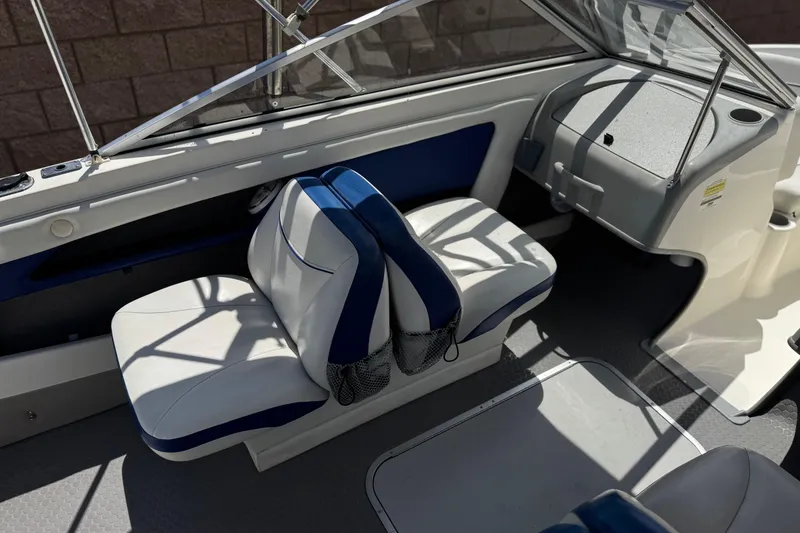 Slide: The Image of 2006 Bayliner 195 Bowrider interior with white and blue seating. - 17
