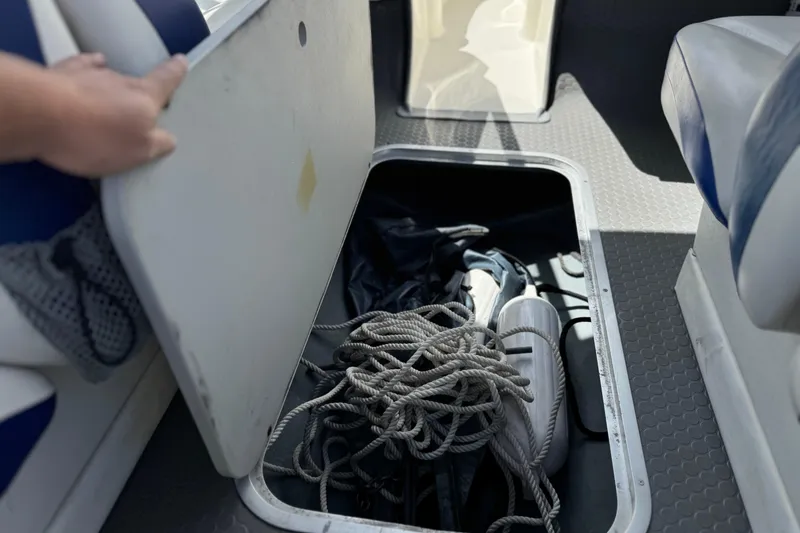 Slide: The Image of Storage compartment in a 2006 Bayliner 195 Bowrider, containing ropes and boating equipment. - 20
