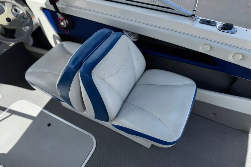 Slide: The Image of 2006 Bayliner 195 Bowrider interior with white and blue seating. - 21