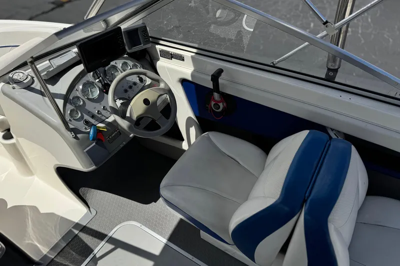 Slide: The Image of Interior of a 2006 Bayliner 195 Bowrider boat showing steering wheel and dashboard controls. - 22