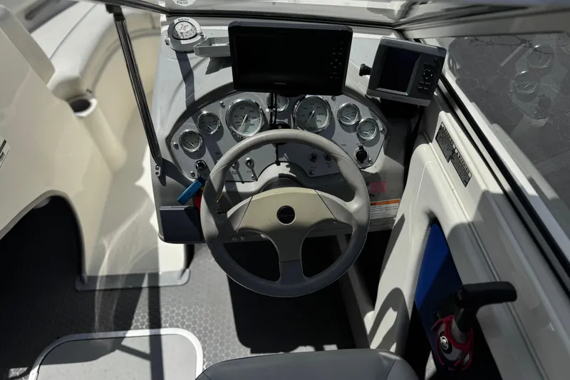 Slide: The Image of 2006 Bayliner 195 Bowrider dashboard with steering wheel and gauges. - 23