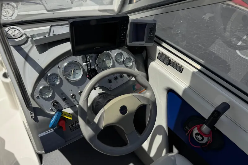 Slide: The Image of 2006 Bayliner 195 Bowrider dashboard with steering wheel and navigation instruments. - 24