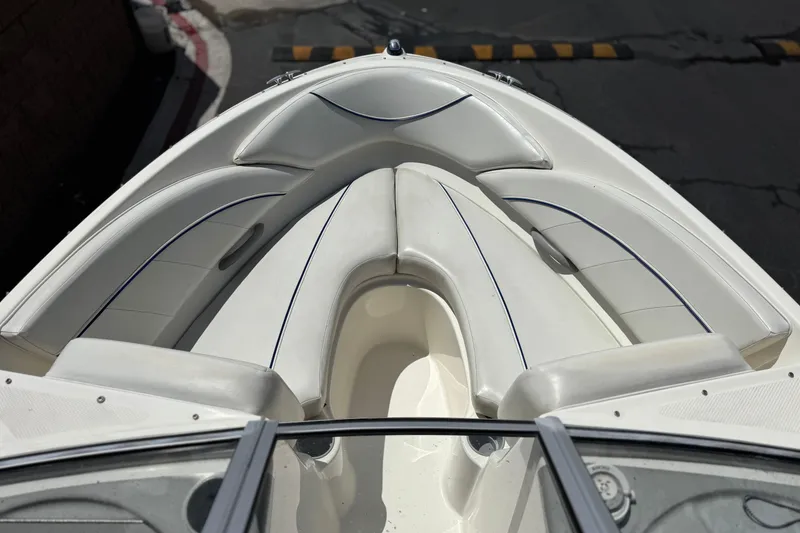 Slide: The Image of 2006 Bayliner 195 Bowrider boat interior with white cushioned seating. - 9