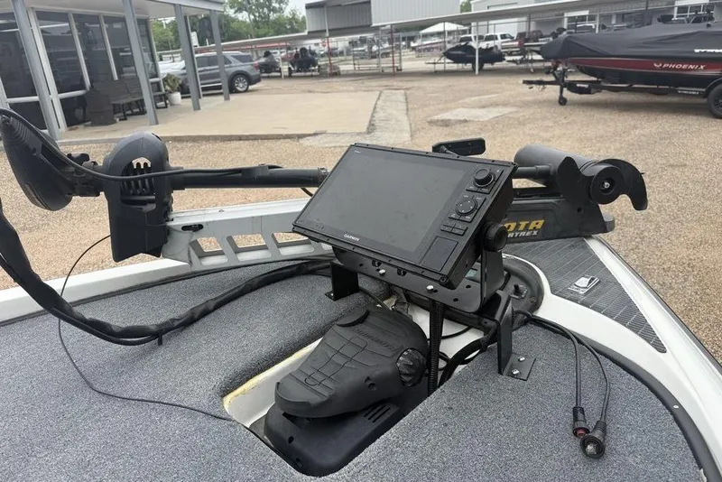 Slide: The Image of 2005 Triton TR-196 boat with advanced navigation system and trolling motor in a dealership lot. - 14