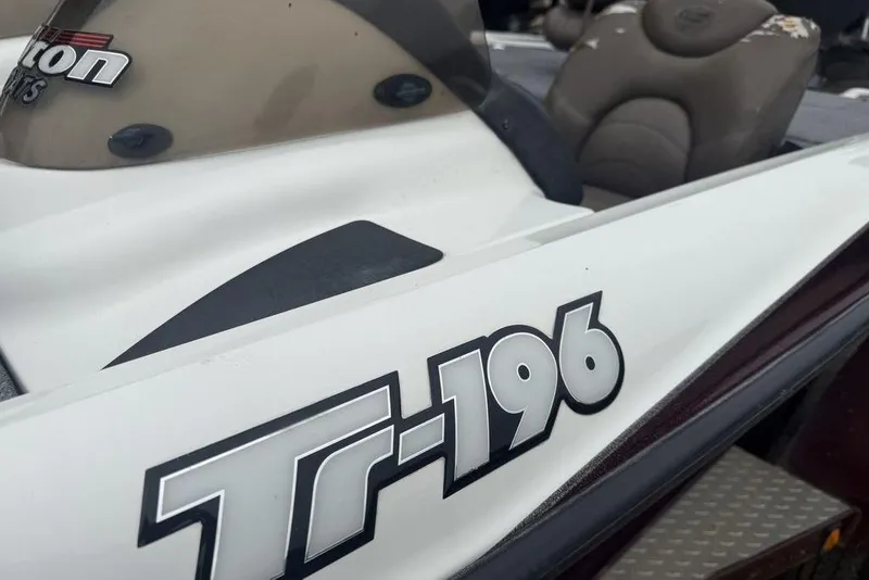Slide: The Image of 2005 Triton TR-196 boat, close-up of model decal and seating area. - 15