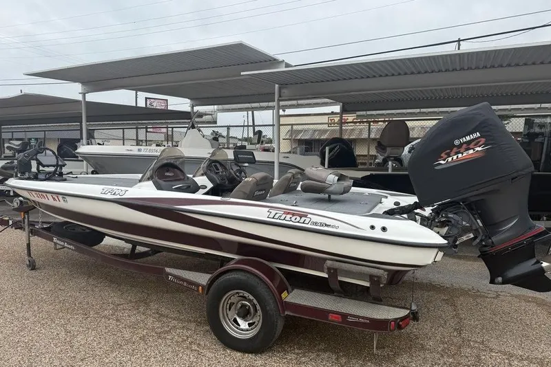 Slide: The Image of 2005 Triton TR-196 boat with Yamaha engine on trailer, parked under shelter. - 3