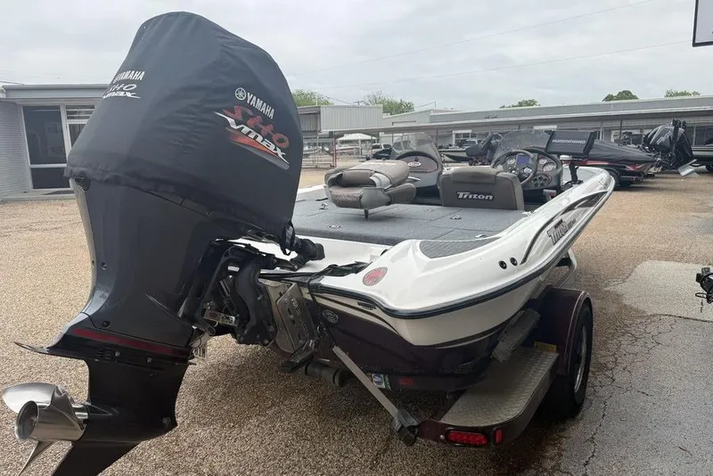 Slide: The Image of 2005 Triton TR-196 boat with Yamaha VMAX engine in a parking lot. - 4