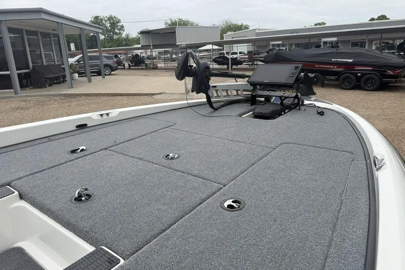 Slide: The Image of 2005 Triton TR-196 boat deck with fishing equipment and storage compartments. - 5