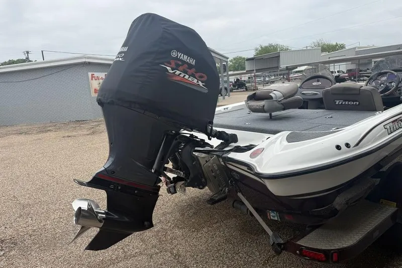 Slide: The Image of 2005 Triton TR-196 boat with Yamaha VMAX outboard motor in a parking area. - 8