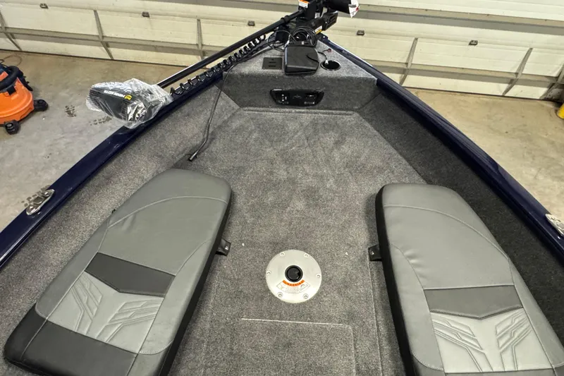 Slide: The Image of 2026 Tracker Pro Guide V-175 Combo boat interior with gray seating and carpeted deck. - 15