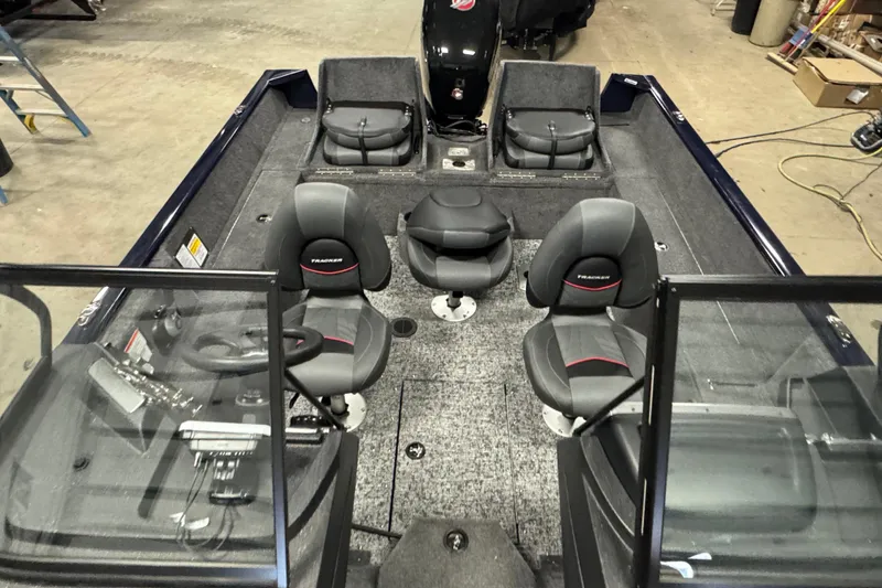 Slide: The Image of 2026 Tracker Pro Guide V-175 Combo boat interior with seating and steering console. - 18