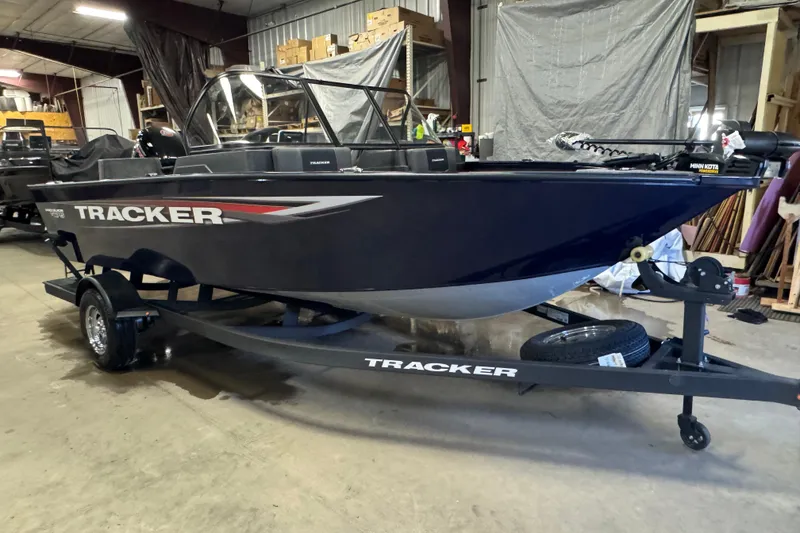 Slide: The Image of 2026 Tracker Pro Guide V-175 Combo boat in a warehouse setting. - 2