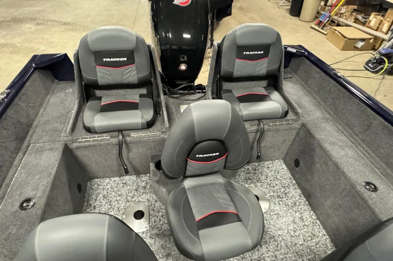 Slide: The Image of 2026 Tracker Pro Guide V-175 Combo boat interior with gray seating and carpeted flooring. - 9