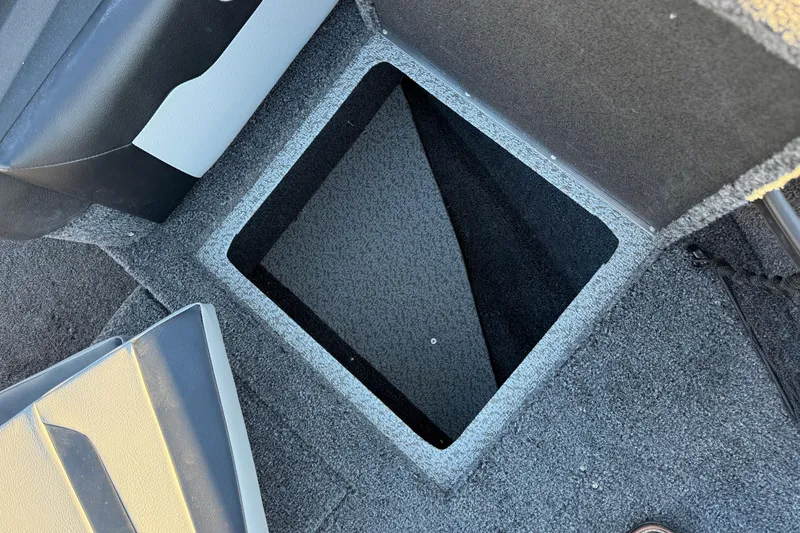Slide: The Image of Open storage compartment in 2026 Crestliner 1850 Super Hawk boat, featuring carpeted interior. - 11