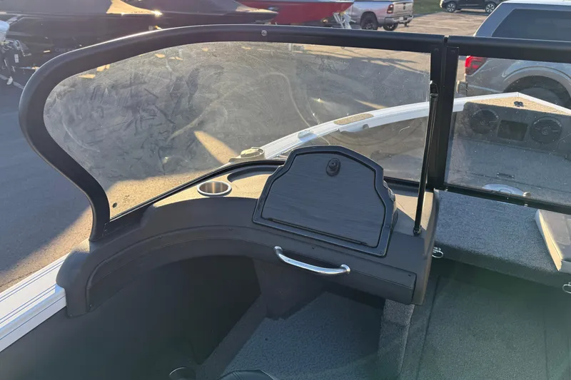 Slide: The Image of 2026 Crestliner 1850 Super Hawk boat dashboard with windshield and storage compartment. - 15