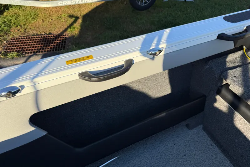 Slide: The Image of Interior view of 2026 Crestliner 1850 Super Hawk boat, featuring handle and storage area. - 18