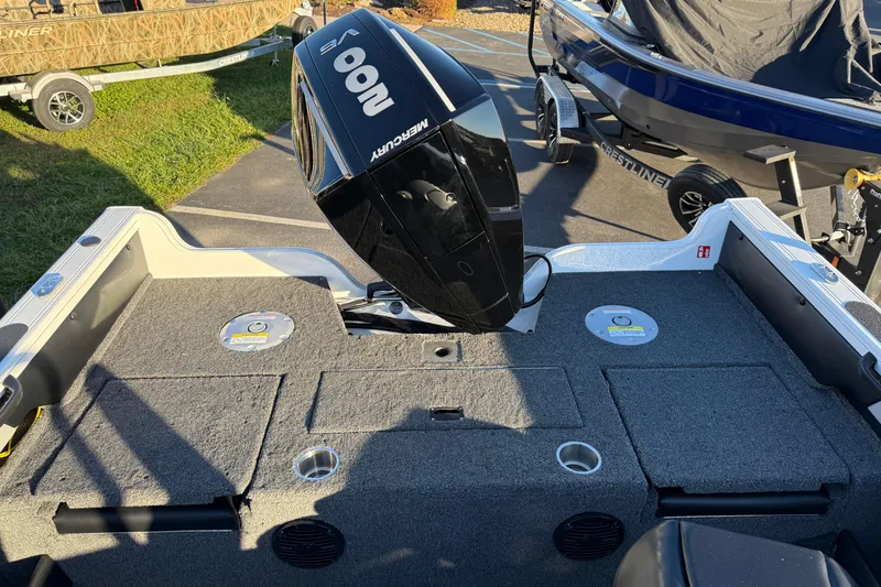 Slide: The Image of 2026 Crestliner 1850 Super Hawk boat with Mercury outboard motor, parked on a trailer. - 21