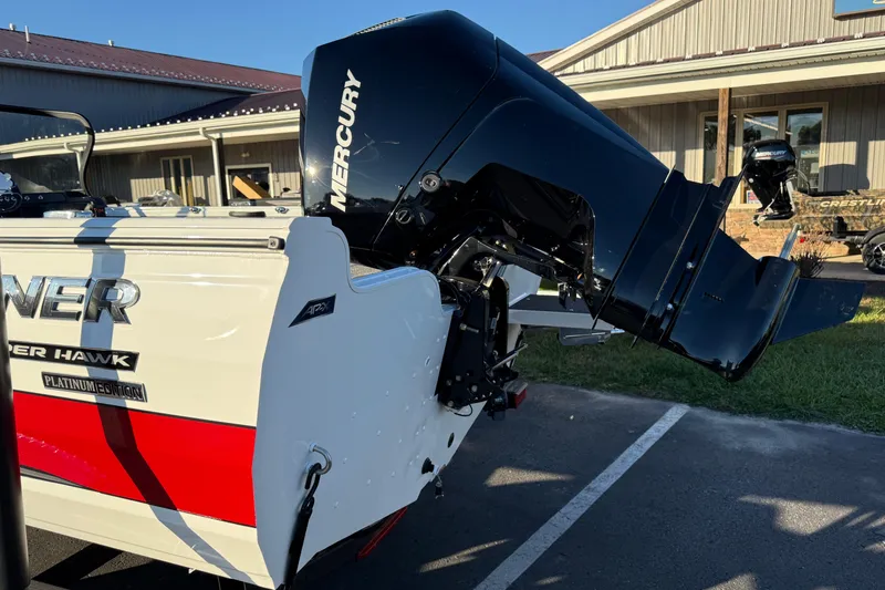 Slide: The Image of 2026 Crestliner 1850 Super Hawk boat with Mercury outboard engine, parked outdoors. - 3
