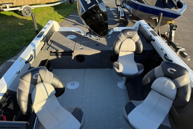 Slide: The Image of 2026 Crestliner 1850 Super Hawk interior with four seats and a Mercury outboard motor. - 9