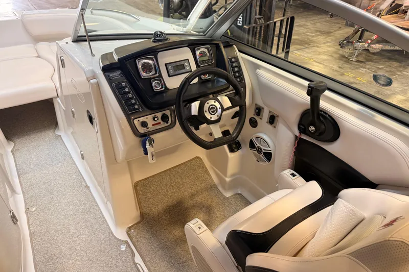Slide: The Image of 2009 Chaparral Sunesta 224 Xtreme boat interior with steering wheel and control panel. - 10