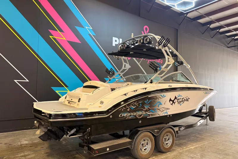 Slide: The Image of 2009 Chaparral Sunesta 224 Xtreme boat on trailer, vibrant indoor setting. - 3
