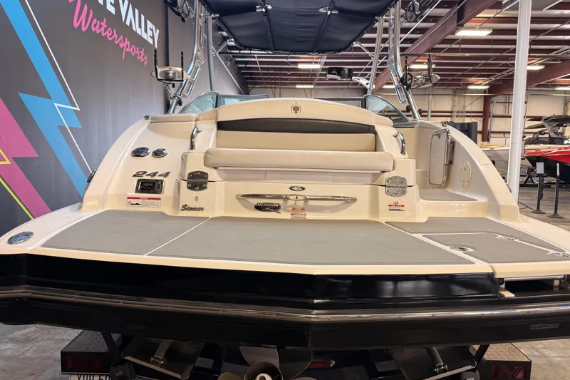 Slide: The Image of 2009 Chaparral Sunesta 224 Xtreme boat in showroom, rear view with seating and swim platform. - 4