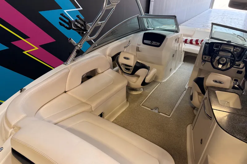 Slide: The Image of 2009 Chaparral Sunesta 224 Xtreme boat interior with white seating and modern dashboard. - 5