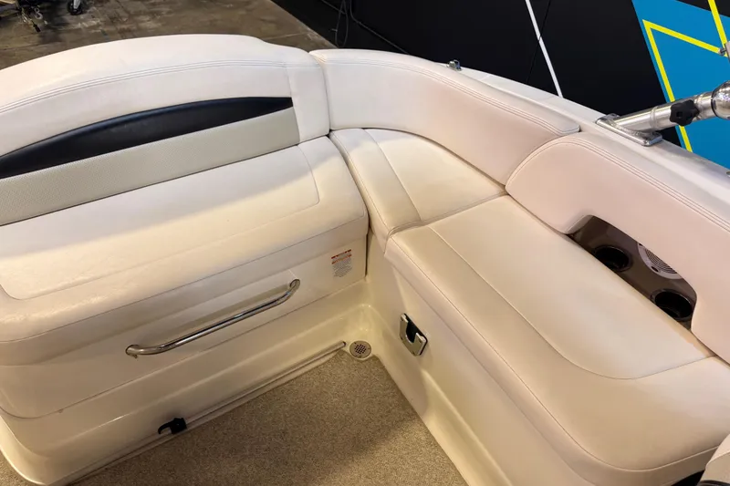Slide: The Image of 2009 Chaparral Sunesta 224 Xtreme boat interior with beige seating and cup holders. - 6