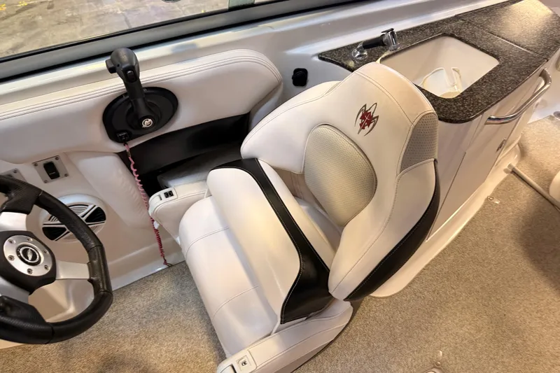 Slide: The Image of 2009 Chaparral Sunesta 224 Xtreme boat interior with steering wheel and captain's chair. - 8