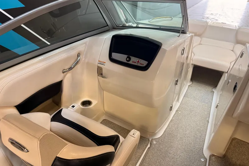 Slide: The Image of Interior of 2009 Chaparral Sunesta 224 Xtreme boat, featuring seating and helm area. - 9