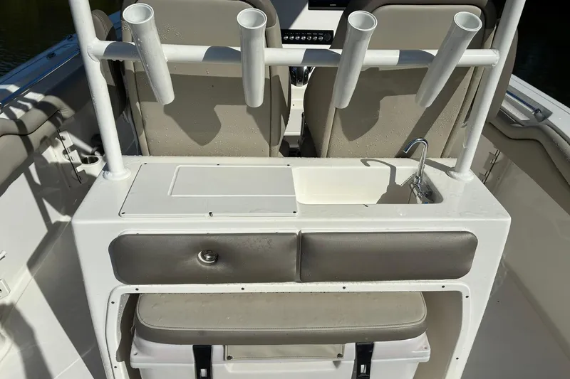 Slide: The Image of 2022 Key West 263 FS boat interior with rod holders and sink station. - 10