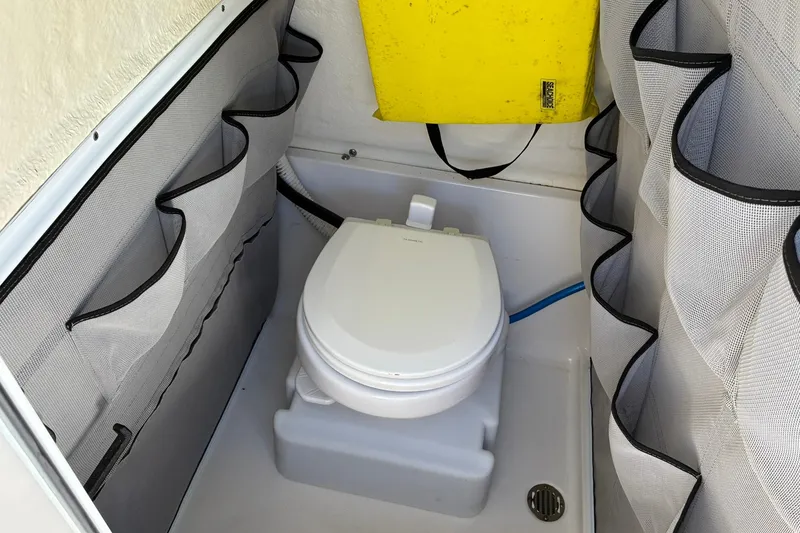 Slide: The Image of Compact marine toilet in 2022 Key West 263 FS boat with storage pockets. - 14