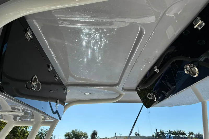 Slide: The Image of 2022 Key West 263 FS boat interior ceiling with storage compartments and latches. - 15
