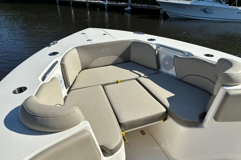 Slide: The Image of 2022 Key West 263 FS boat with spacious seating area and cup holders on calm water. - 16